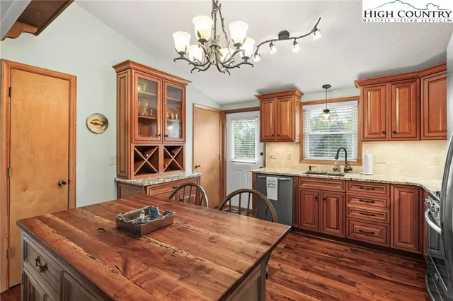a kitchen with a table chairs stove and cabinets
