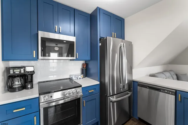 a kitchen with granite countertop stainless steel appliances and wooden cabinets