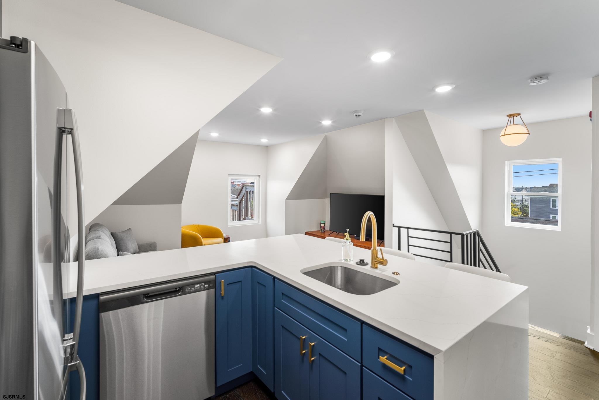 1059 Asbury Avenue, Unit 3 Ocean City, NJ 08226 - Photo 4 of 14 a kitchen with a sink a refrigerator and a stove