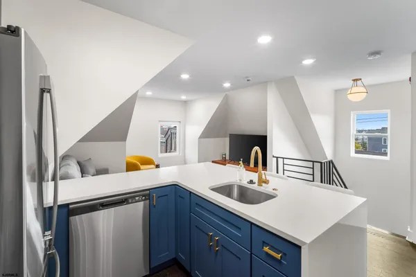 a kitchen with a sink a refrigerator and a stove