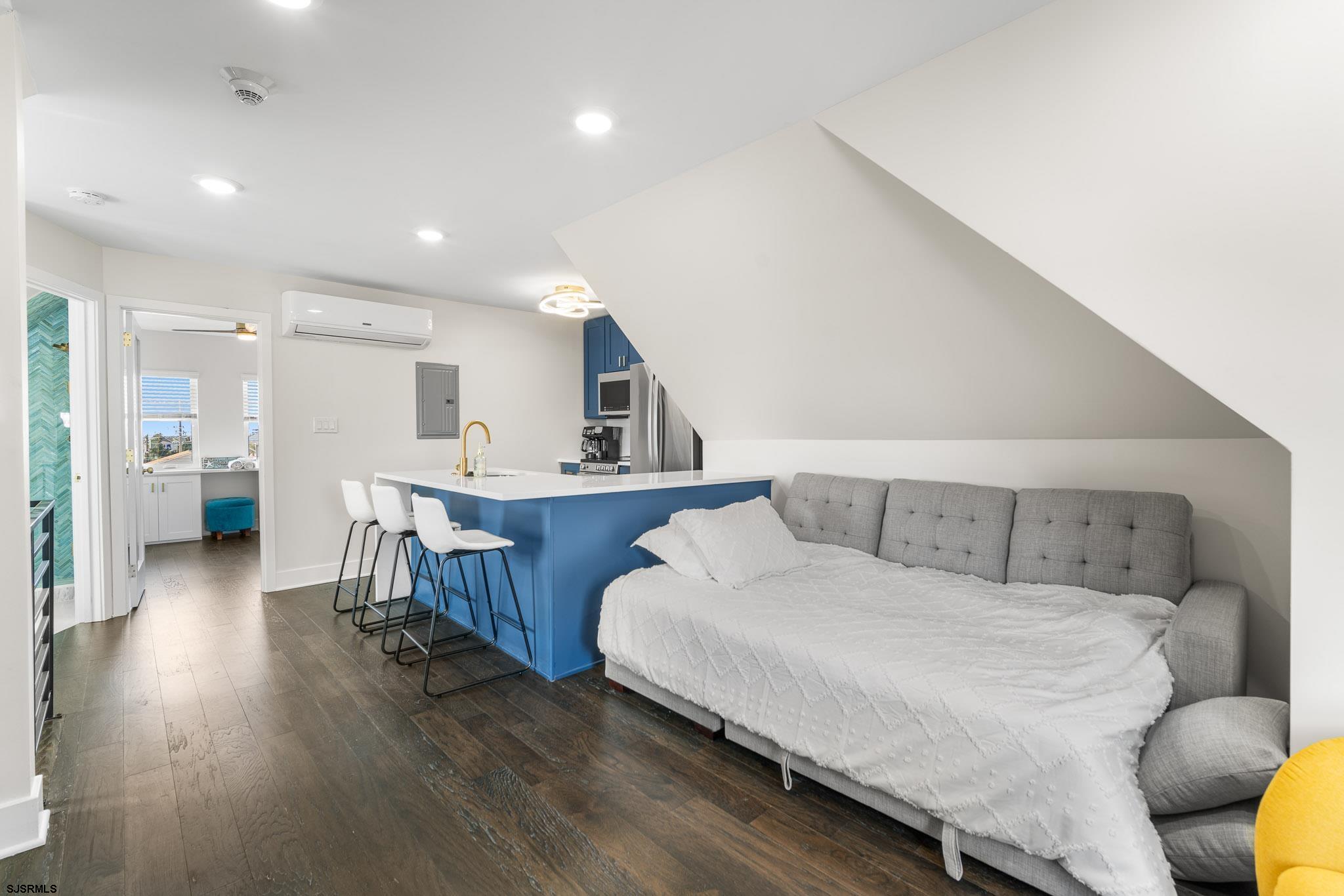 1059 Asbury Avenue, Unit 3 Ocean City, NJ 08226 - Photo 8 of 14 a living room with furniture and a wooden floor