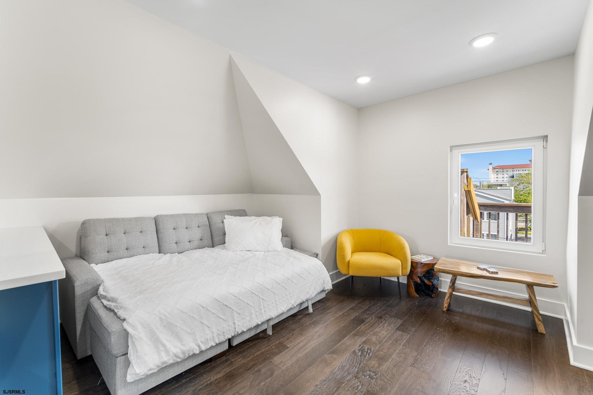 1059 Asbury Avenue, Unit 3 Ocean City, NJ 08226 - Photo 9 of 14 a bedroom with a bed and window