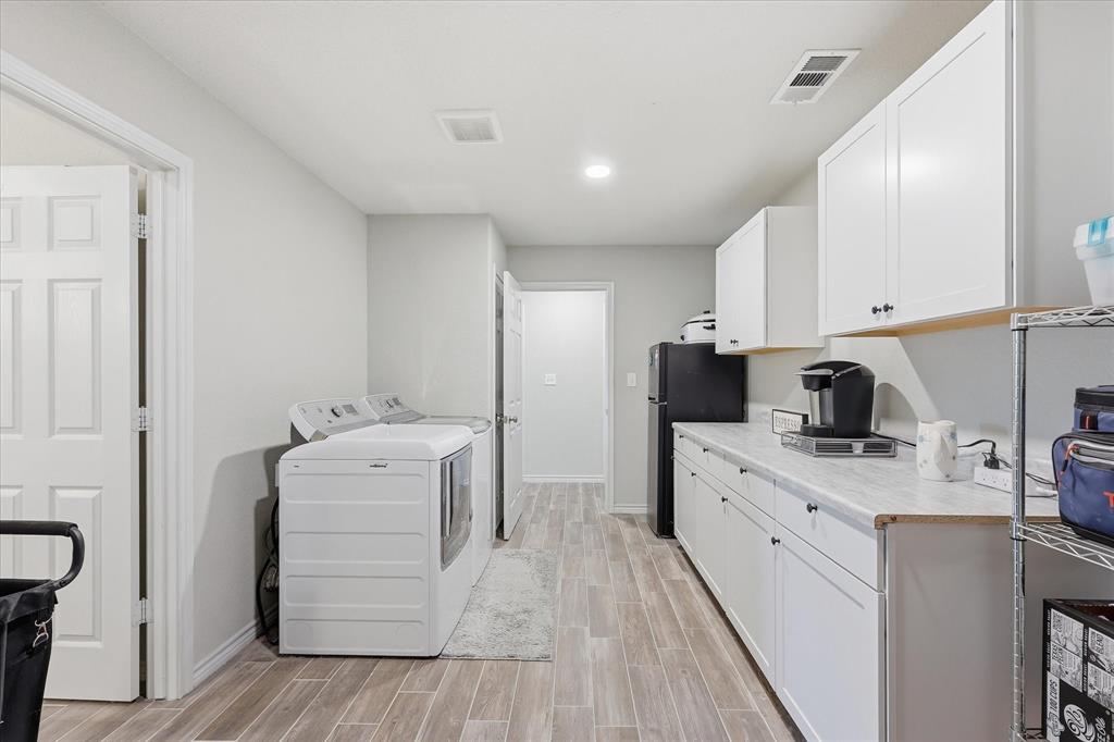 110 Highview Road Ennis, TX 75119 - Photo 20 of 40 Utility room featuring wood-finish flooring, white cabinetry with black hardware, a long countertop, and recessed lighting
