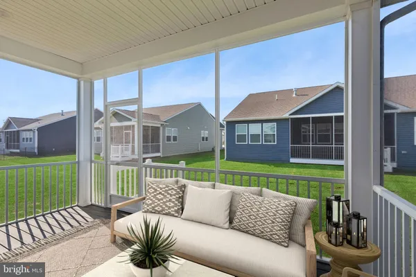 a view of a house and a couches in a patio