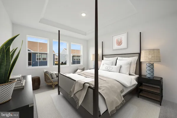 a bedroom with a bed wooden floor and lamp