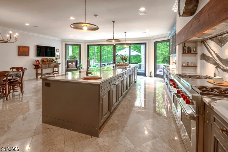 5 Burnett Road Mendham, NJ 07945 - Photo 9 of 50 a dining hall with stainless steel appliances granite countertop a stove and a view of living room