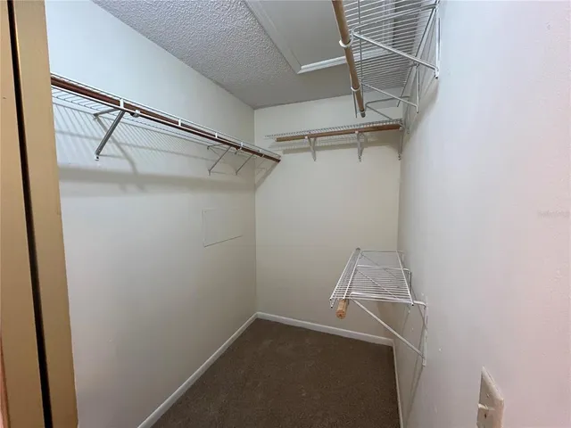 an empty room with a fan and a fan