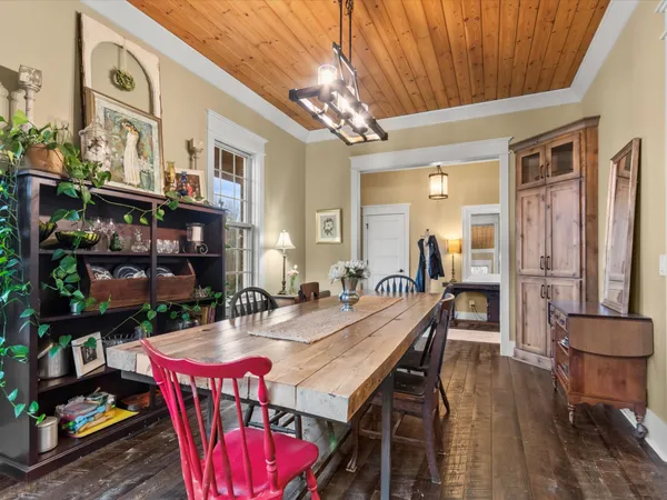 a dining room with furniture and wooden floor