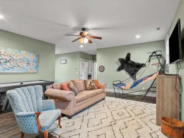 a living room with furniture a rug and white walls