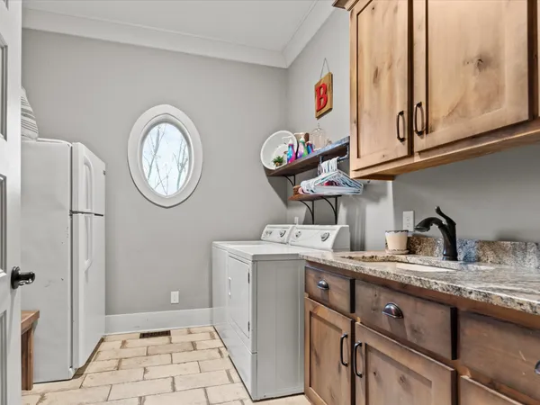 a kitchen with a stove a clock and a refrigerator