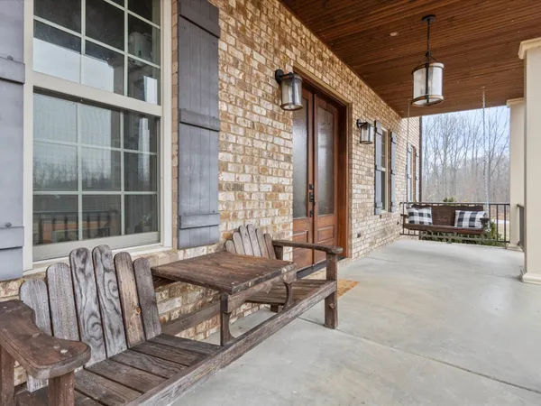 a living room with furniture and large windows