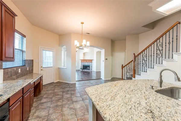 a view of a house with a yard and wooden fence