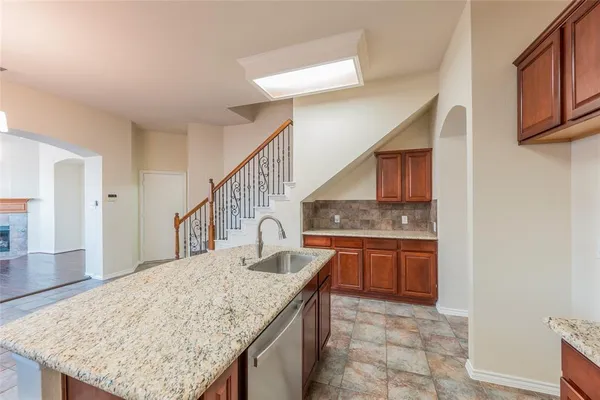 a large kitchen with kitchen island granite countertop a sink stove and refrigerator