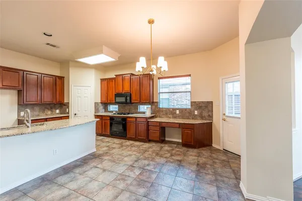 a kitchen with granite countertop a sink and stove