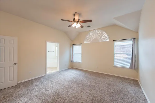 a large kitchen with kitchen island granite countertop a stove a sink a counter space and cabinets