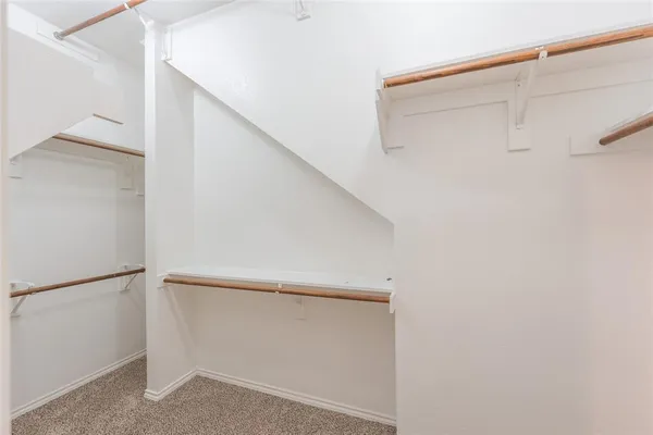 a view of an empty room with a ceiling fan
