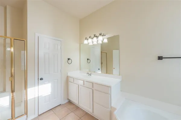 a bathroom with a bathtub a sink and a mirror