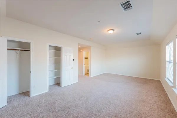 a spacious bathroom with a double vanity sink and mirror