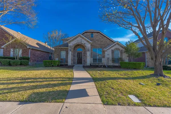 a front view of a house with swimming pool having outdoor seating