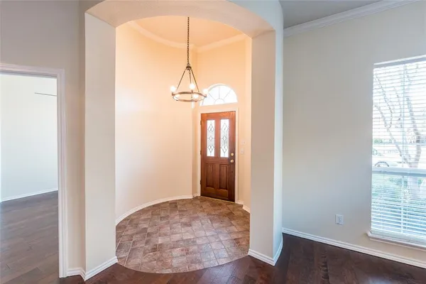 an entryway door with wooden floor