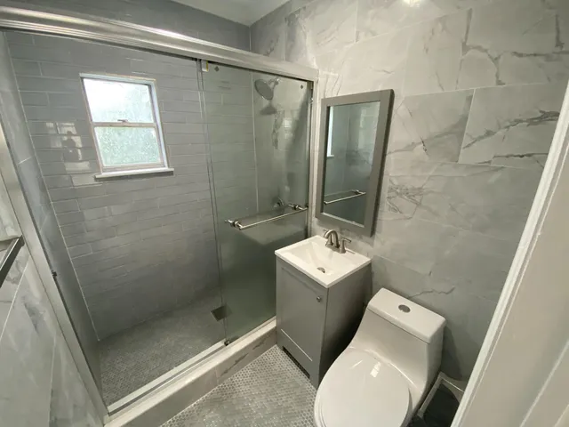 a bathroom with a toilet and a shower