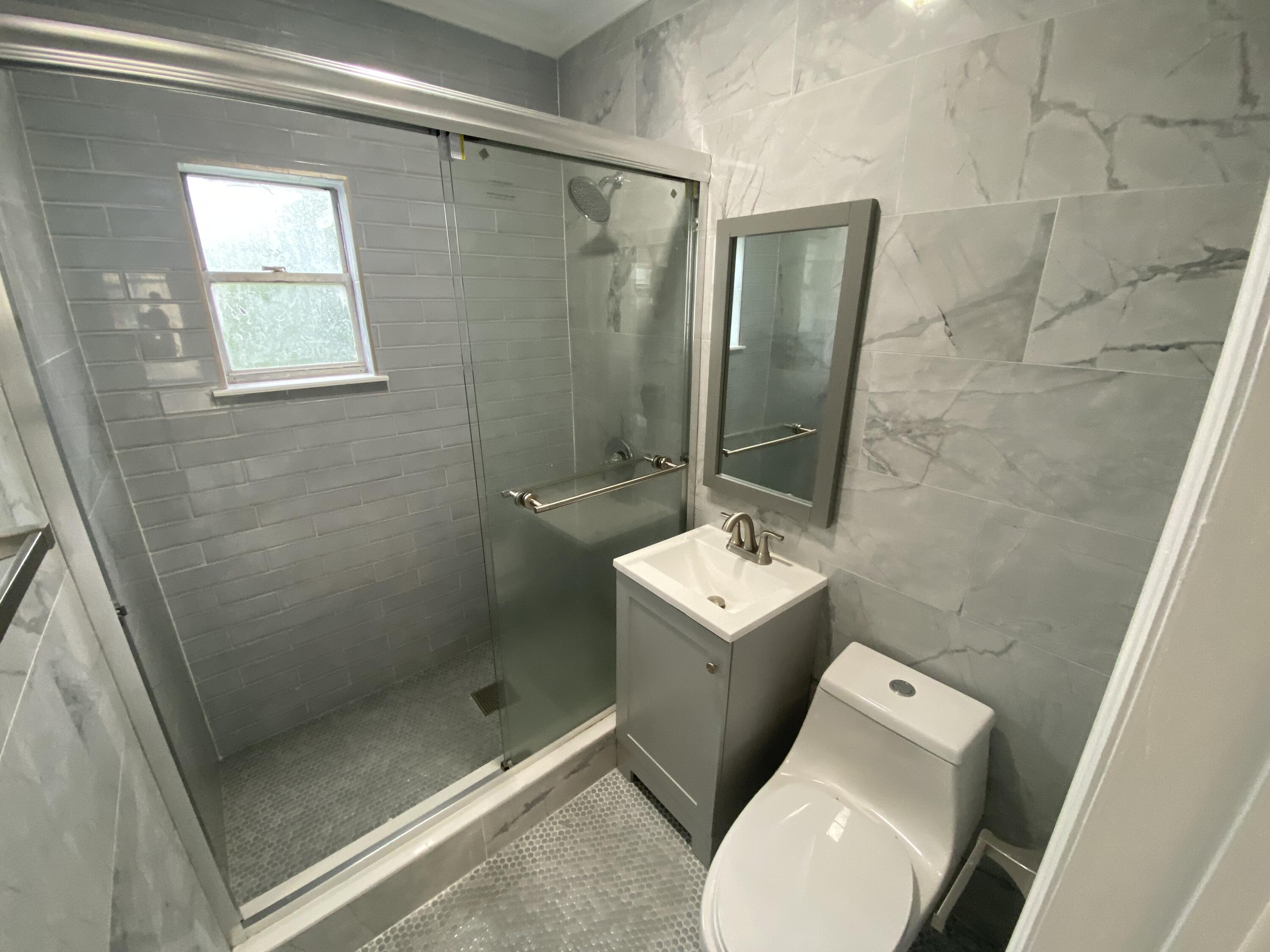 301 South M Street, Unit 5 Lake Worth Beach, FL 33460 - Photo 12 of 17 a bathroom with a toilet and a shower