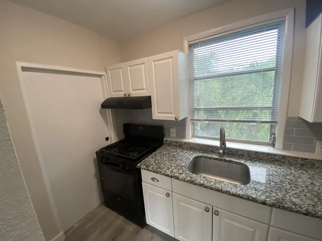 a kitchen with sink and window