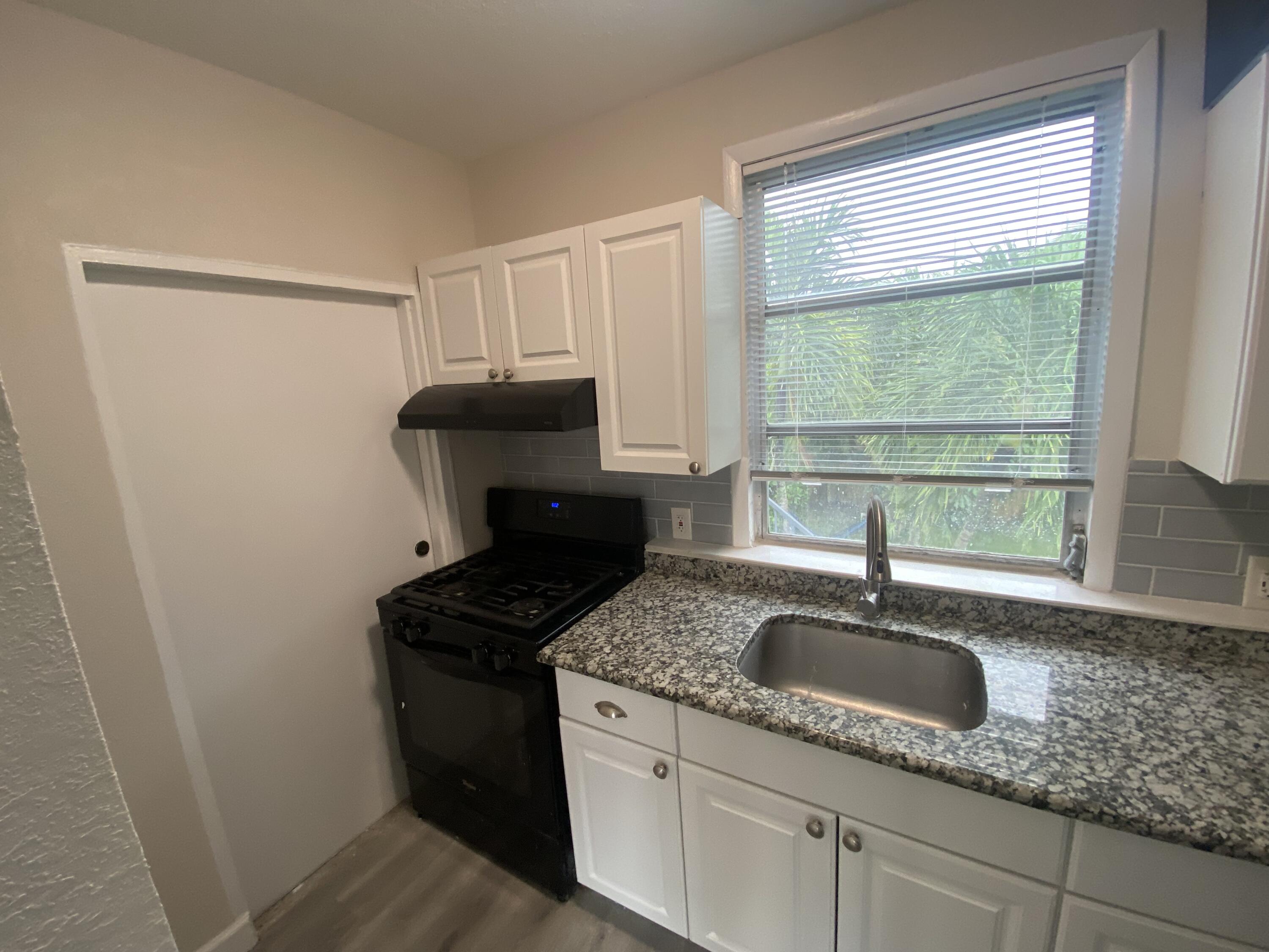 301 South M Street, Unit 5 Lake Worth Beach, FL 33460 - Photo 16 of 17 a kitchen with sink and window