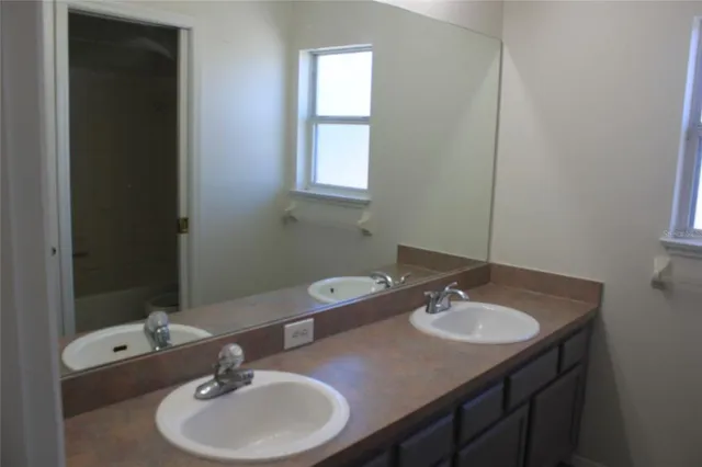 a bathroom with a sink and a mirror