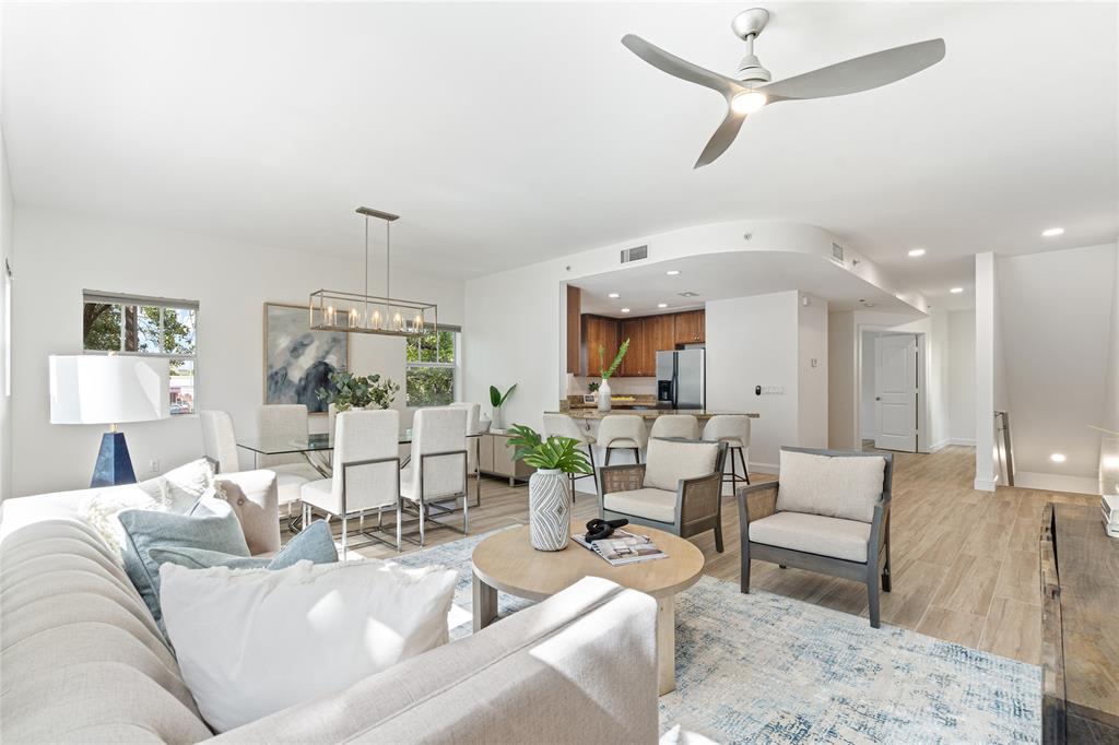 a living room with furniture and a chandelier