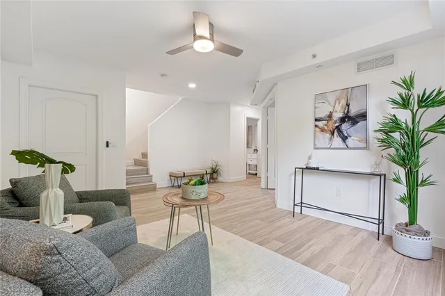 a living room with furniture and a potted plant