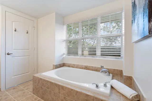 a bath tub sitting in a bathroom next to a window