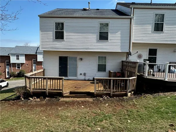 a view of a house with wooden deck