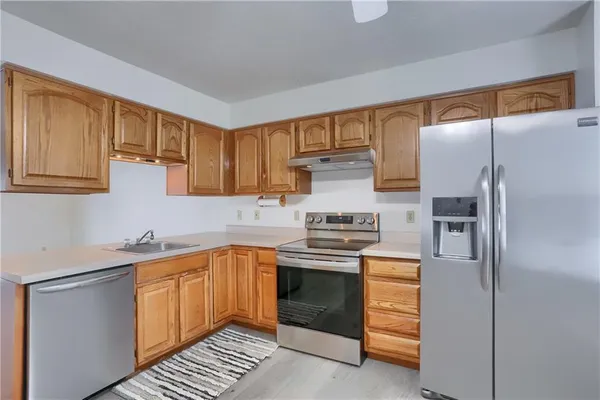 a kitchen with a sink stove and refrigerator