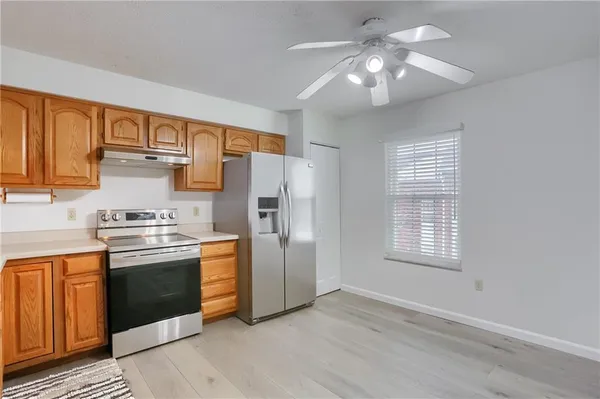 a kitchen with stainless steel appliances granite countertop a stove and a refrigerator