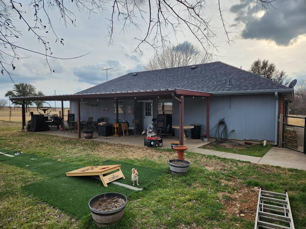 a view of a backyard with table and chairs and a fire pit