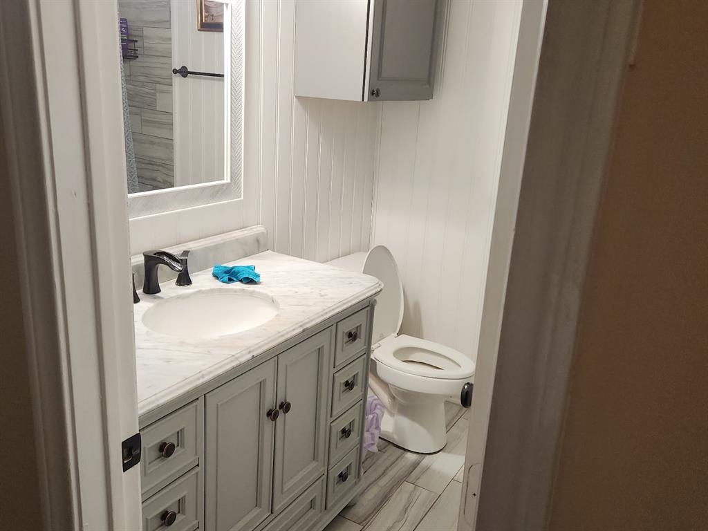 541 Bakers Branch Road Waxahachie, TX 75167 - Photo 11 of 13 a bathroom with a granite countertop toilet sink and mirror