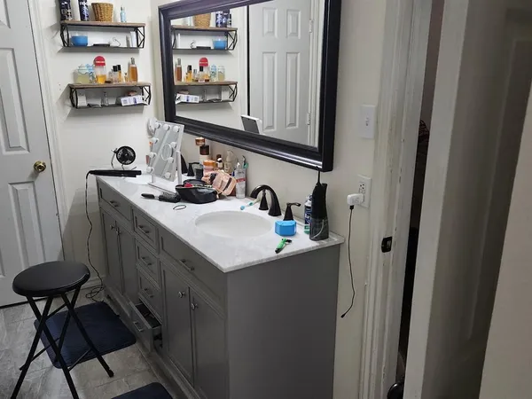 a bathroom with a sink and a mirror