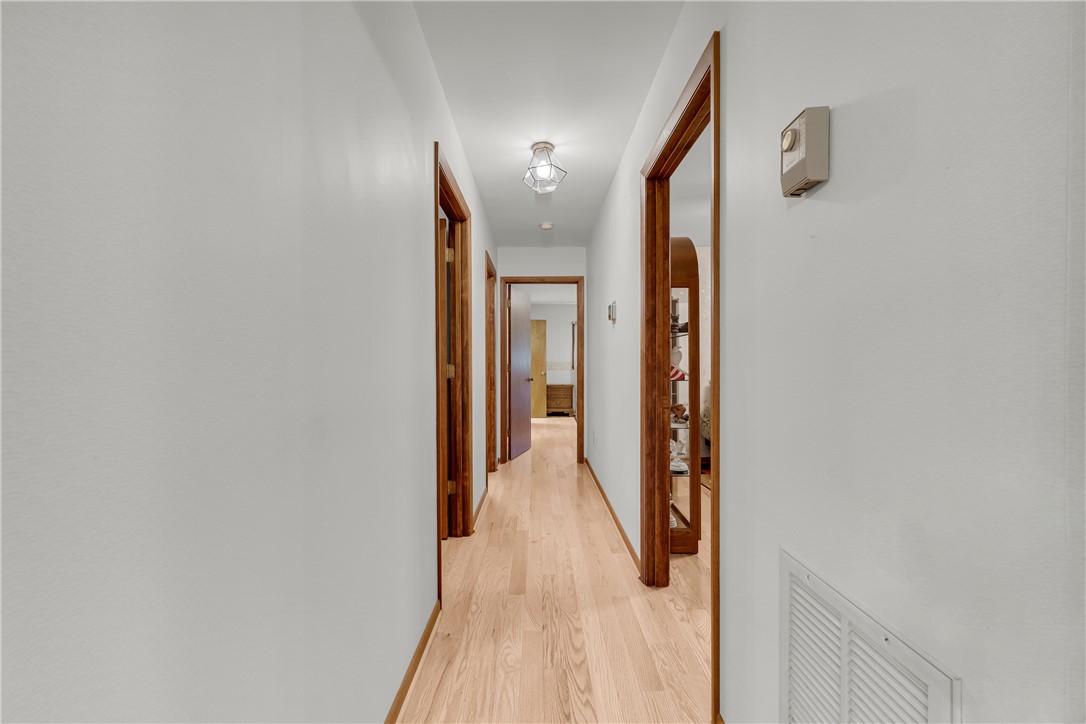 103 Colleton Court Clemson, SC 29631 - Photo 28 of 49 Smooth hardwood floors run the length of a hallway accented by classic wooden door frames.