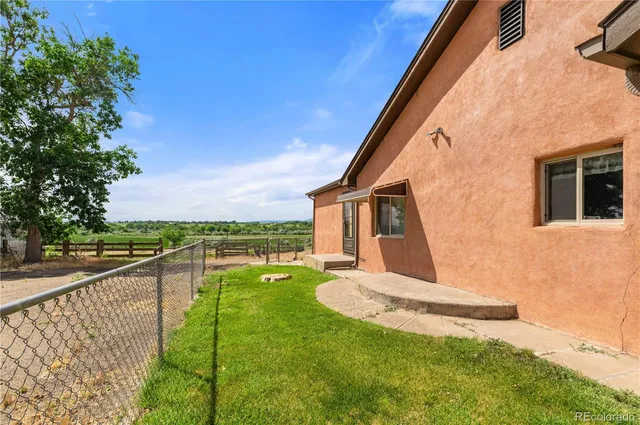 a view of a backyard with wooden fence