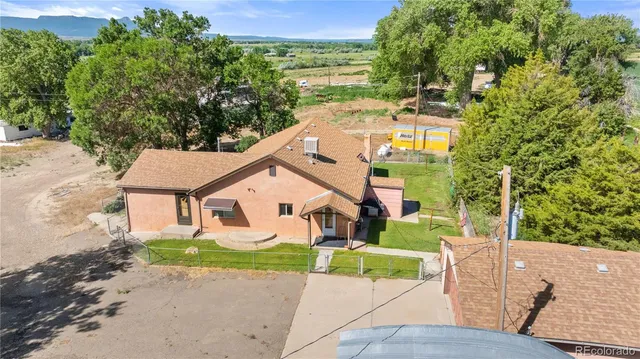 a aerial view of a house with a yard and potted plants