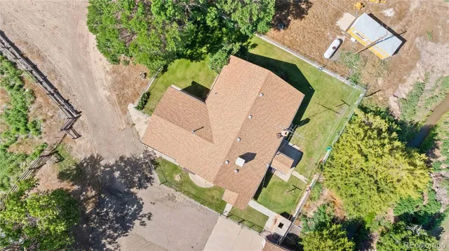 an aerial view of a house with a yard