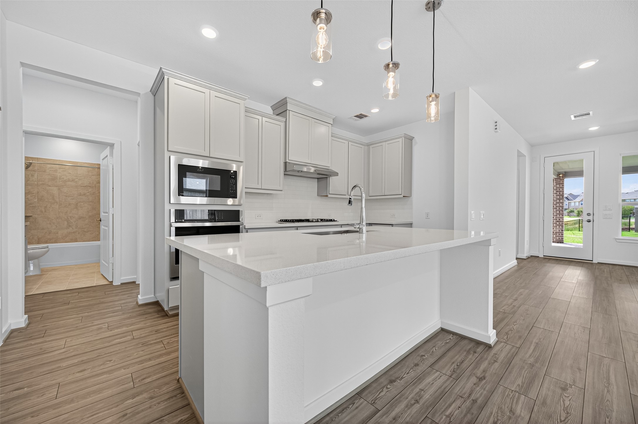 4702 Rustic Grv Lane Fulshear, TX 77441 - Photo 15 of 37 a kitchen with kitchen island a sink stainless steel appliances and cabinets