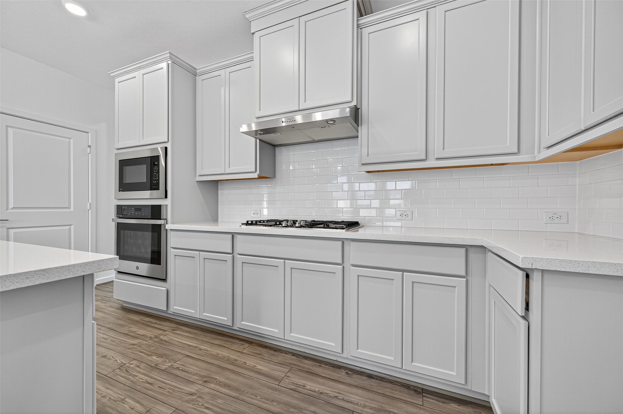 4702 Rustic Grv Lane Fulshear, TX 77441 - Photo 17 of 37 a kitchen with granite countertop white cabinets and stainless steel appliances
