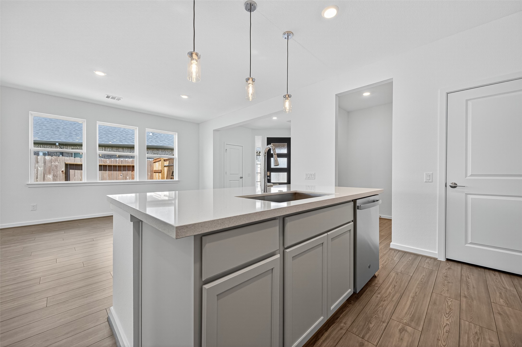 4702 Rustic Grv Lane Fulshear, TX 77441 - Photo 19 of 37 The island is topped with a sleek quartz surface, offering both durability and a polished modern look that elevates the kitchen’s style.