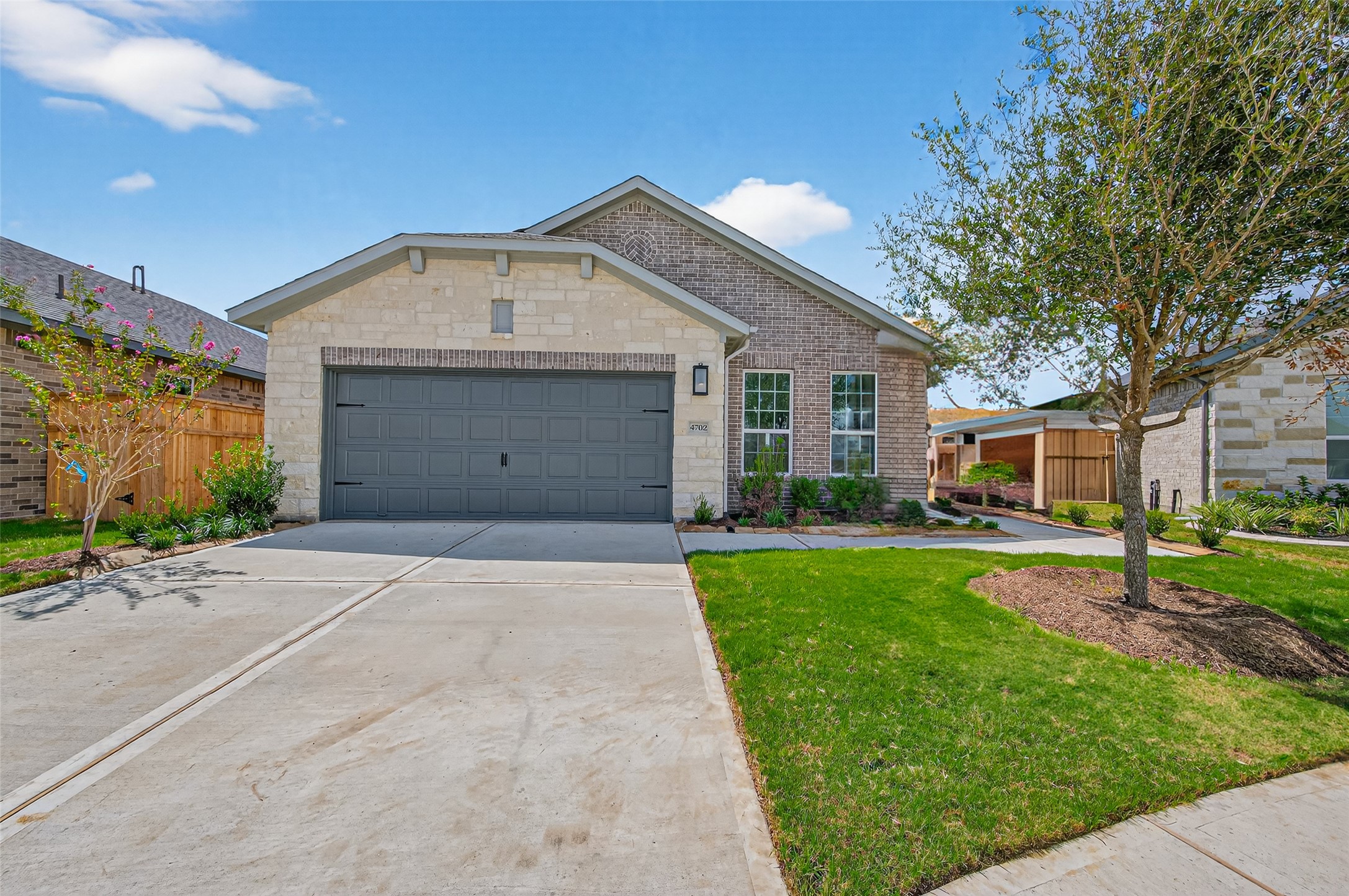 4702 Rustic Grv Lane Fulshear, TX 77441 - Photo 2 of 37 a front view of house with yard and green space