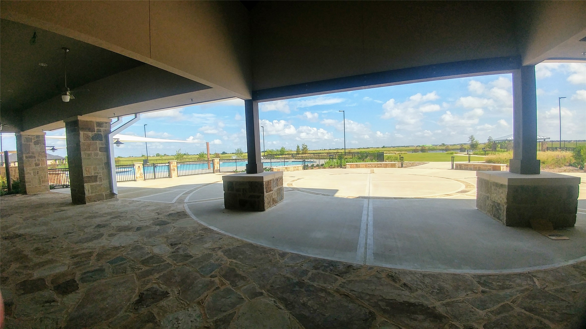 4702 Rustic Grv Lane Fulshear, TX 77441 - Photo 32 of 37 The clubhouse at Bonterra overlooks the sparkling pool and serene lake, offering the perfect spot to relax, socialize, and enjoy resort-style living every day.