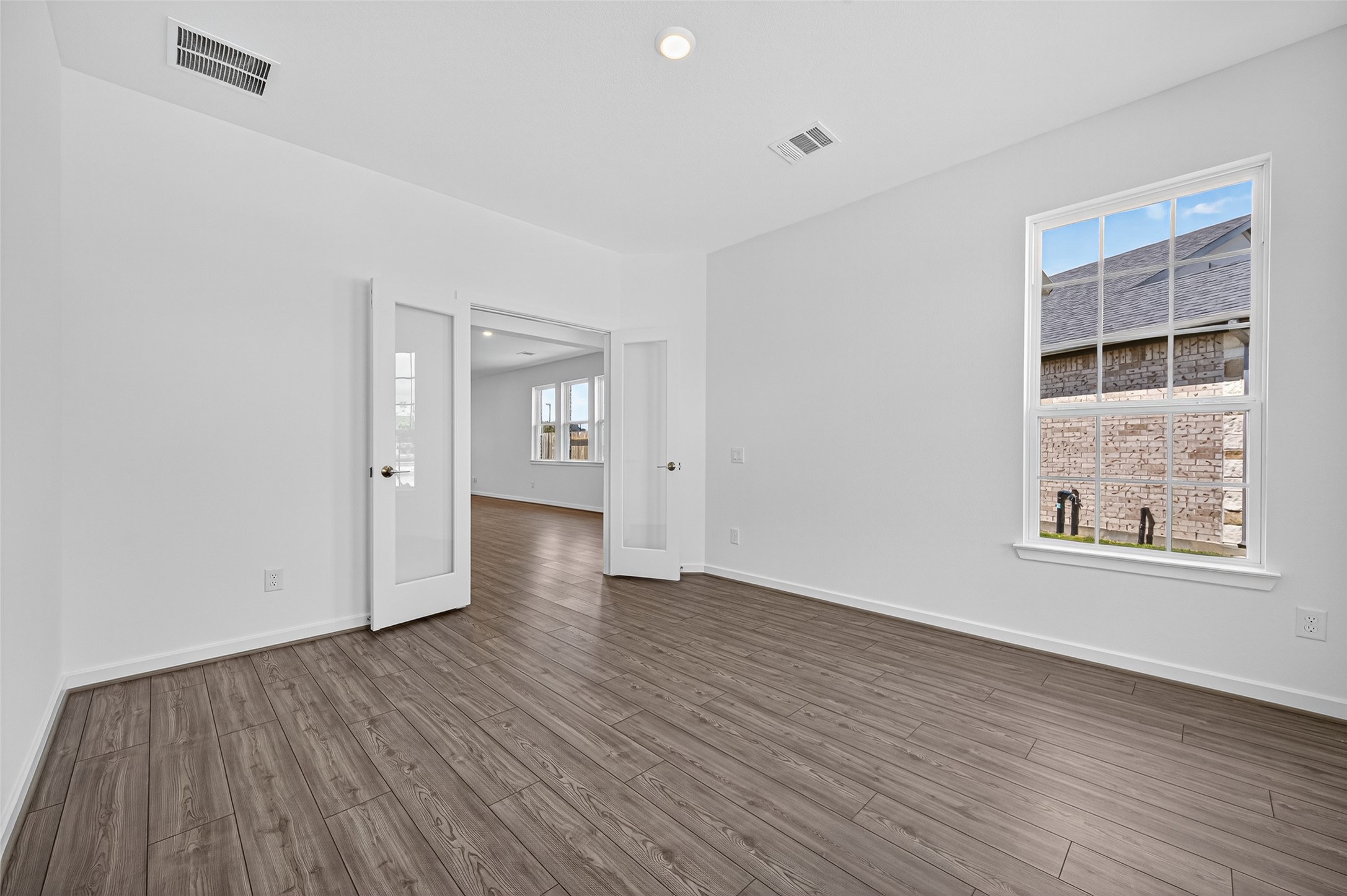 4702 Rustic Grv Lane Fulshear, TX 77441 - Photo 9 of 37 wooden floor in an empty room with a window