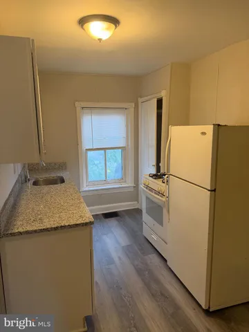 a white refrigerator freezer sitting in a kitchen