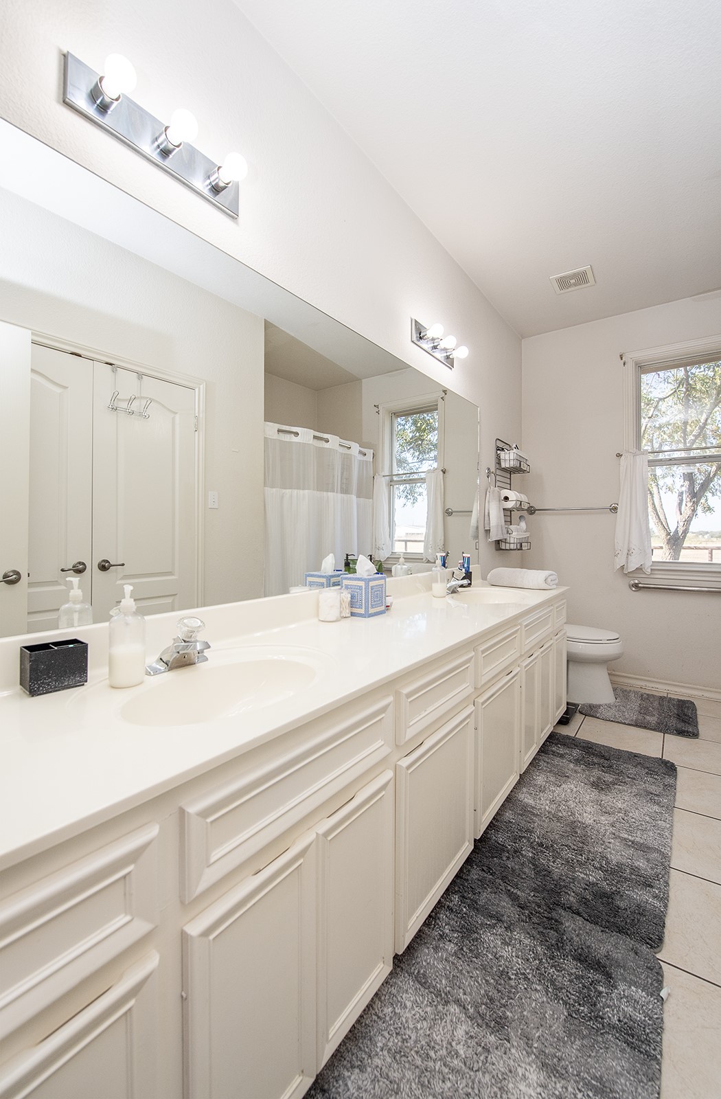 1833 County Road 305 Jarrell, TX 76537 - Photo 27 of 40 Lare hall bathroom with dual vanities and a linen closet
